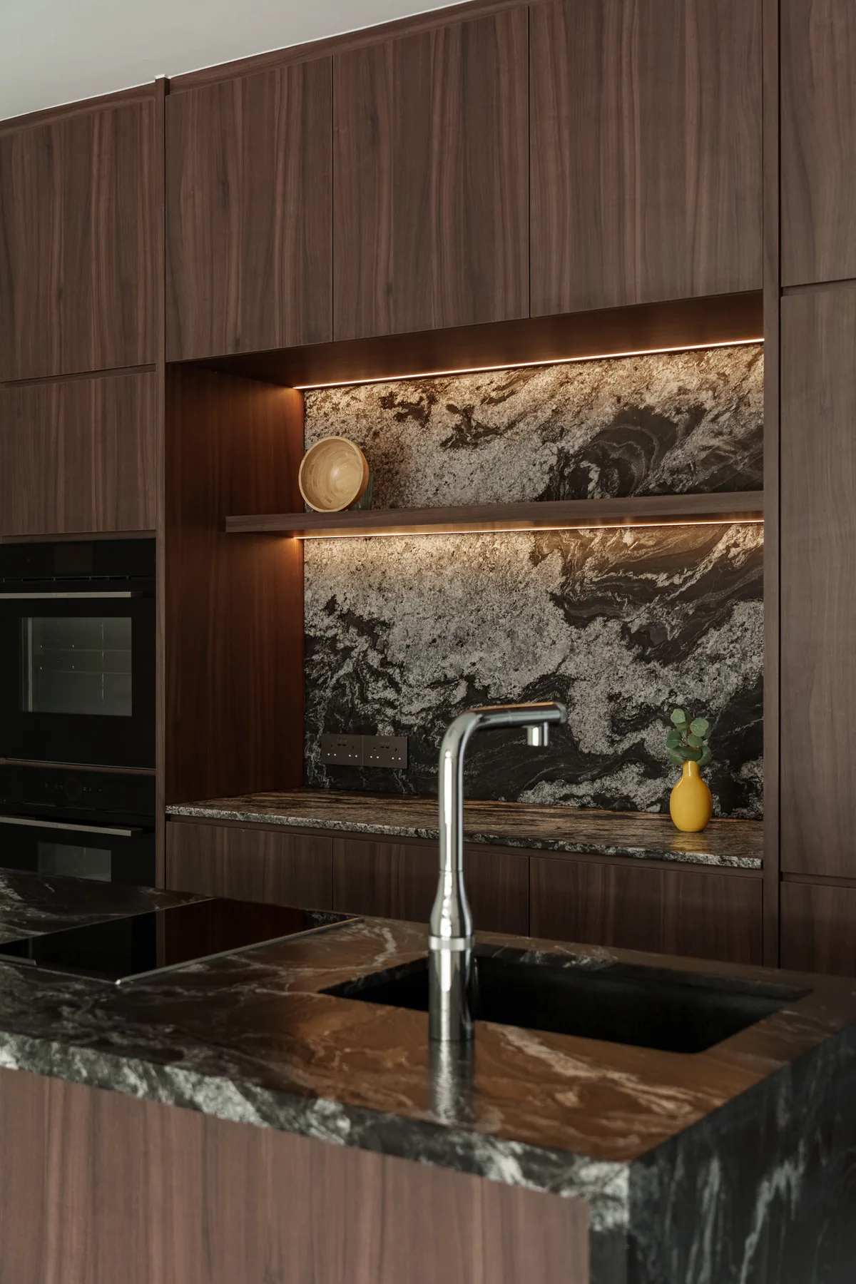 Integrated kitchen cabinetry, stone and appliance detailing at Lorong 108 Changi