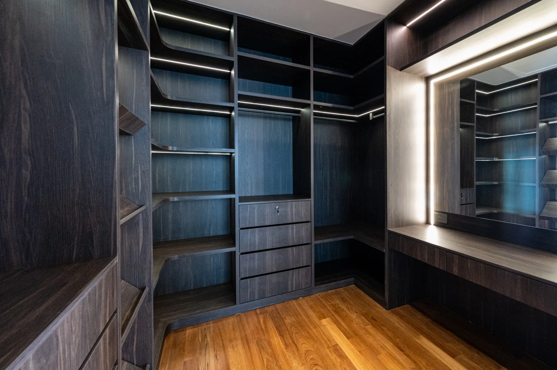 Full-height walk-in wardrobe and illuminated dressing joinery at Coronation Drive